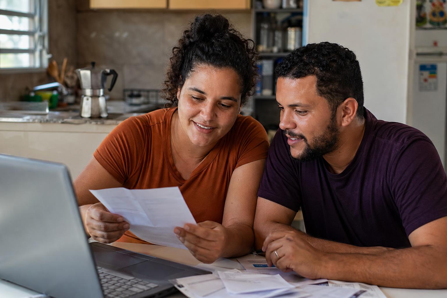 A Puerto Rico resident reviewing her finances at home.